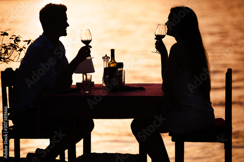 Couple sharing romantic sunset dinner on tropical resort
