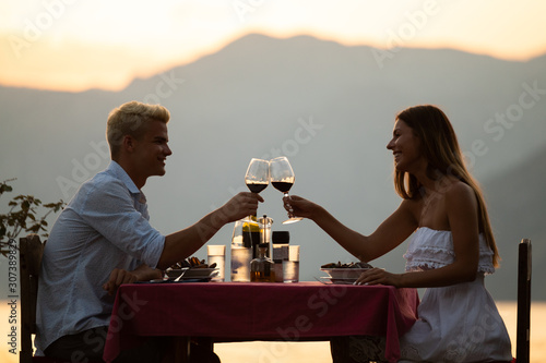 Fototapeta Couple sharing romantic sunset dinner on tropical resort