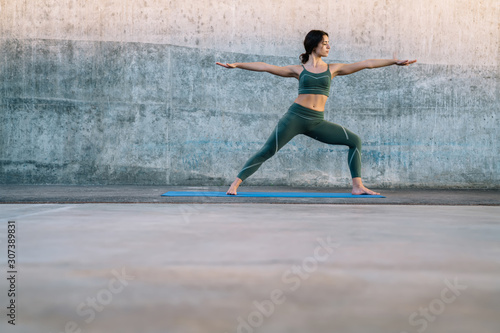 Healthy woman practicing yoga outside