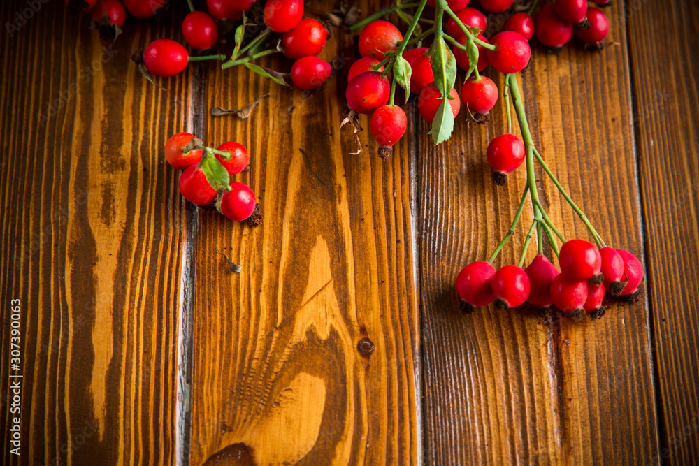 ripe red dogrose in a basket on a wooden