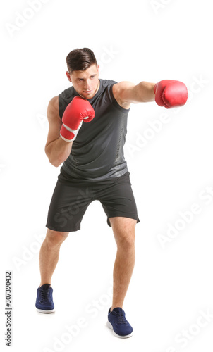 Sporty young boxer on white background