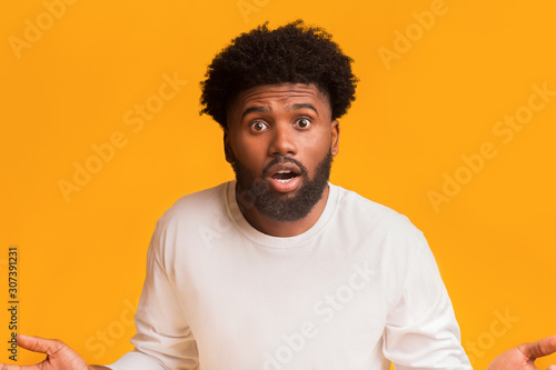 Surprised bearded black man standing with open mouth photo