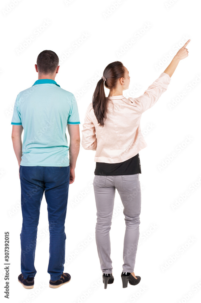 Fototapeta premium Back view of a stylish couple pointing.