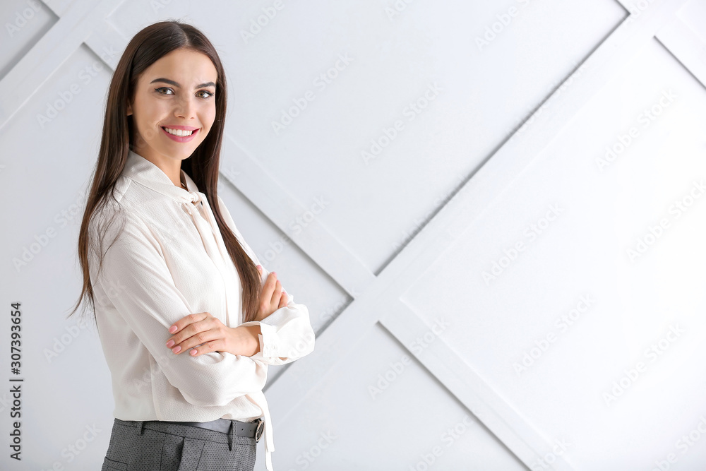 Beautiful young businesswoman on light background Beautiful young businesswoman on light background