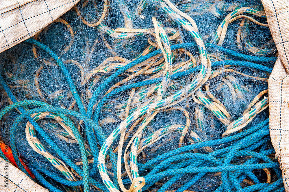 Blue ropes and fishing net in the big sack Blue ropes and fishing net in the big sack