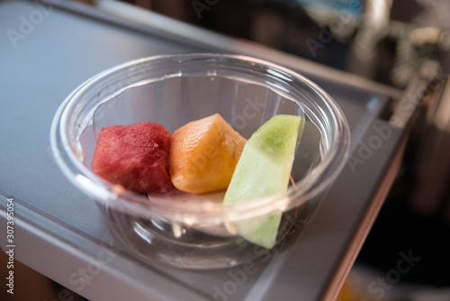 Three fruit pieces on a disposable plastic bowl