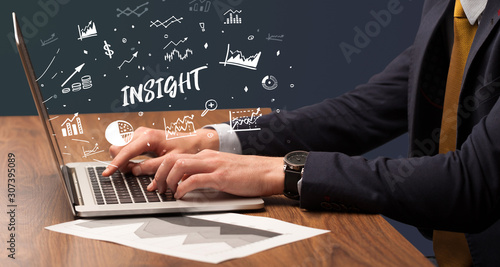 Businessman working on laptop with INSIGHT inscription, modern business concept