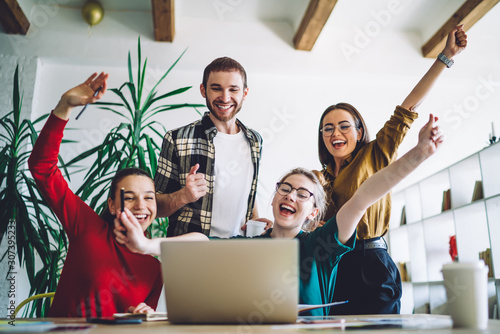 Cheerful friends celebrating homework fulfillment photo