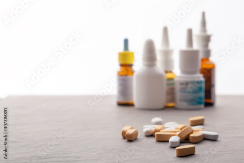 Set medicines for treatment various ailments and symptoms. Pills, supplements for disease. Pile of various pills. Healthcare, tablets blisters, throat spray, bottle therapeutic nose drops, syrup photo