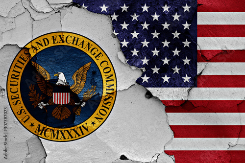 flags of Securities and Exchange Commission and USA painted on cracked wall photo