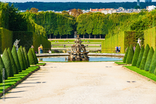 Lovely panoramic landscape view of the Pyramid Fountain, supported by tritons, dolphins and crayfish, in the centre of the north end of the Parterre du Nord in the Gardens of Versailles. photo