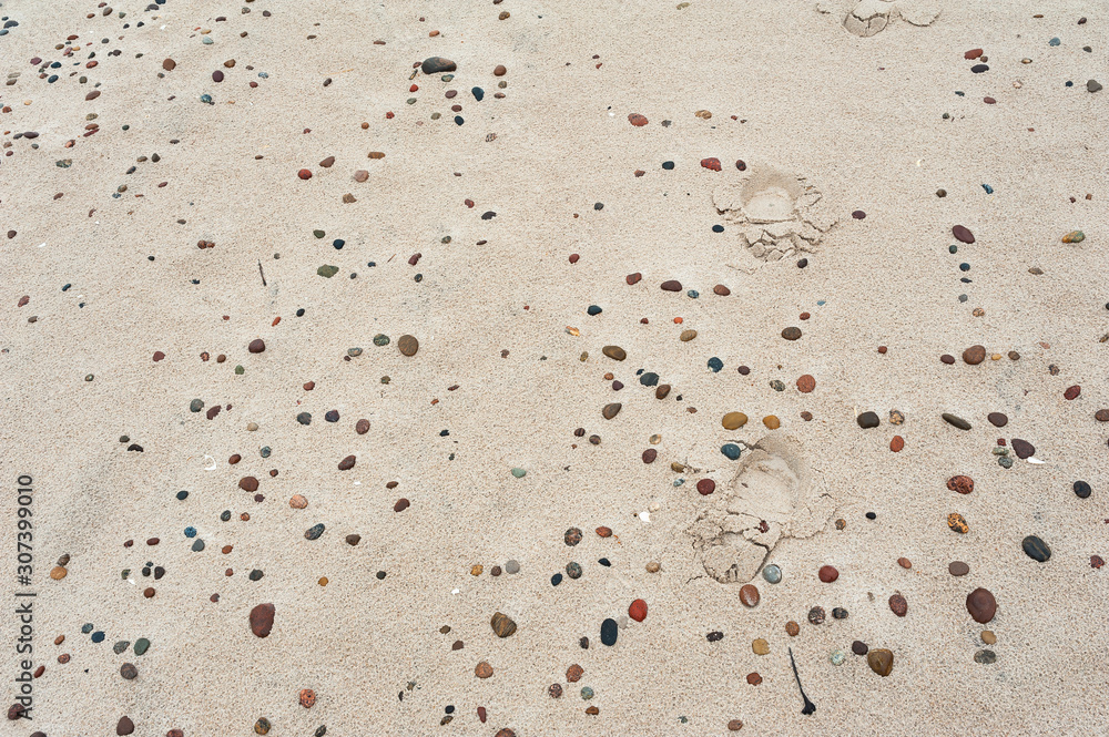 Footprints on the stony beach. Baltic sea, Poland. Footprints on the stony beach. Baltic sea, Poland.