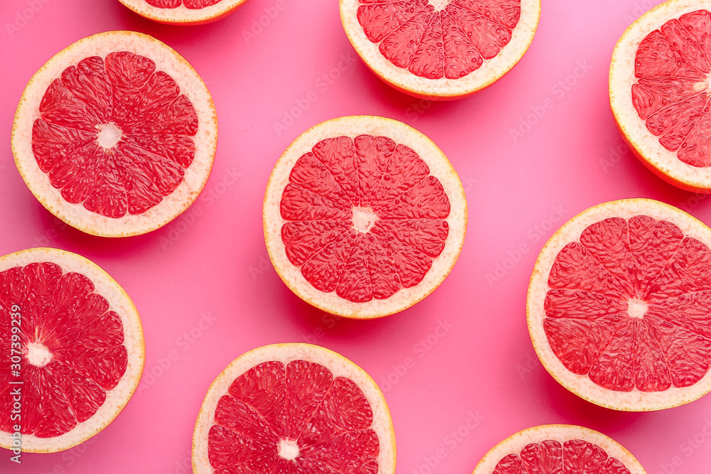 Fresh cut grapefruit on color background