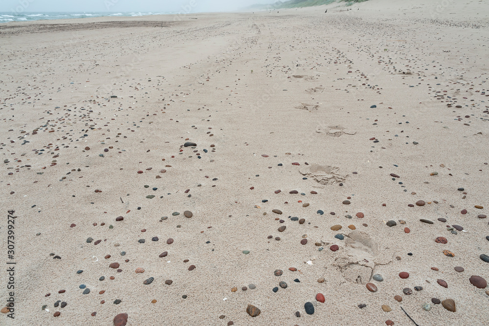 Footprints on the stony beach. Baltic sea, Poland.