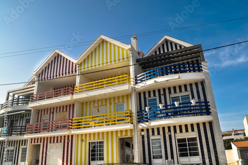 Colorful striped houses called Palheiros.  Atlantic coast beach resort near Aveiro. Colorful Aveiro. Portugal. Summer time