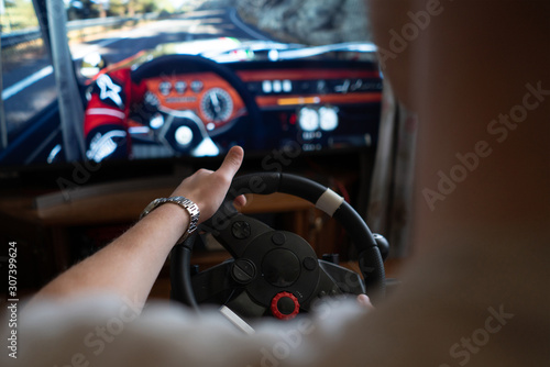 Photos man learns how to drive the car on the virtual  driving auto simulator