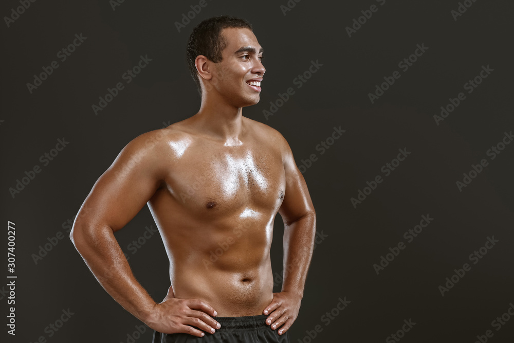 Sporty African-American man on dark background Sporty African-American man on dark background