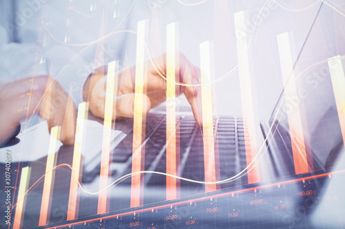 Double exposure of market chart with man working on computer on background. Concept of financial analysis.