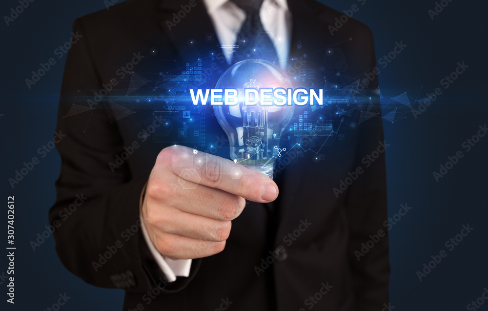 Businessman holding light bulb with WEB DESIGN inscription, innovative technology concept Businessman holding light bulb with WEB DESIGN inscription, innovative technology concept