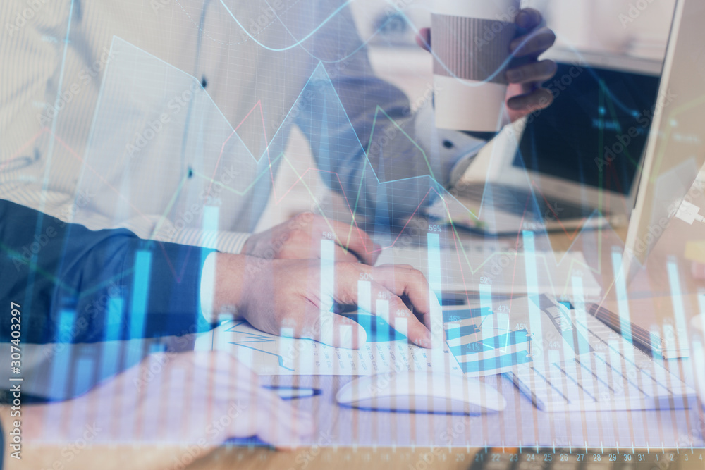 Multi exposure of chart with man typing on computer in office on background. Concept of hard work. Multi exposure of chart with man typing on computer in office on background. Concept of hard work.