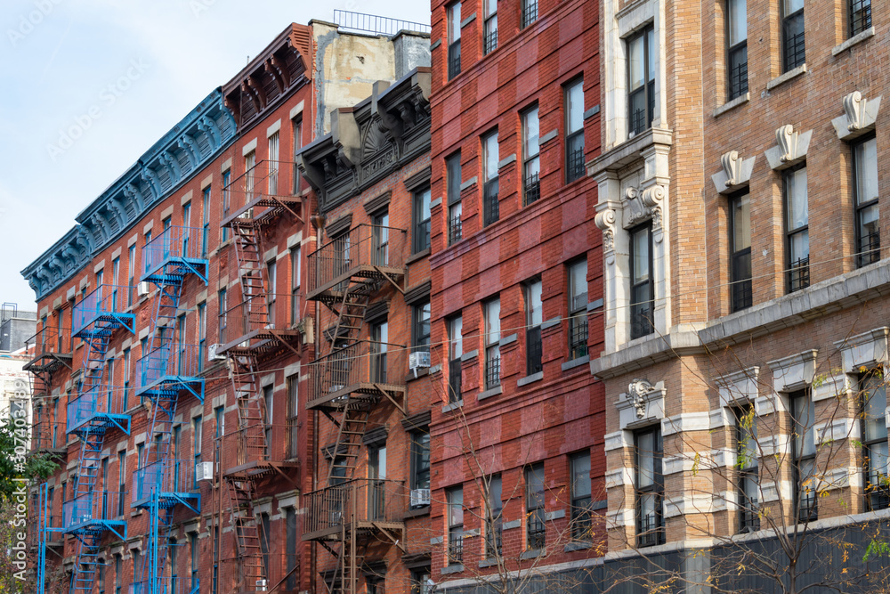 Row of Colorful Old Brick Buildings in the East Village of New York City with Fire Escapes