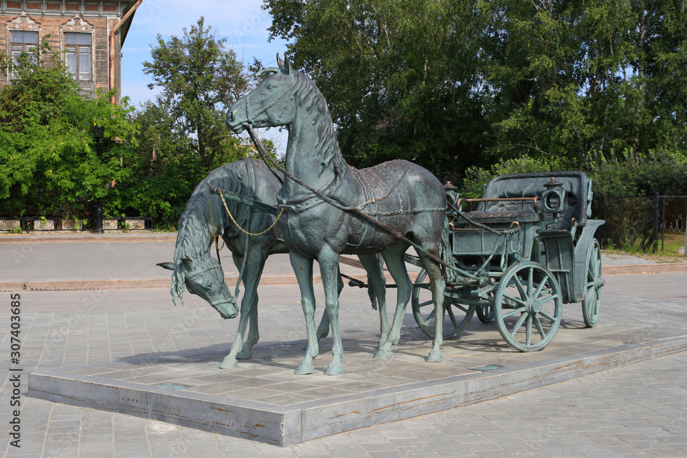 Bronze sculpture carriage with horses on the city square of Tobolsk in Siberia