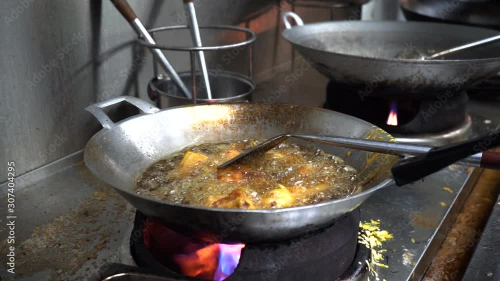 asian deep fried food on wok with oil. asian deep fried food on wok with oil.