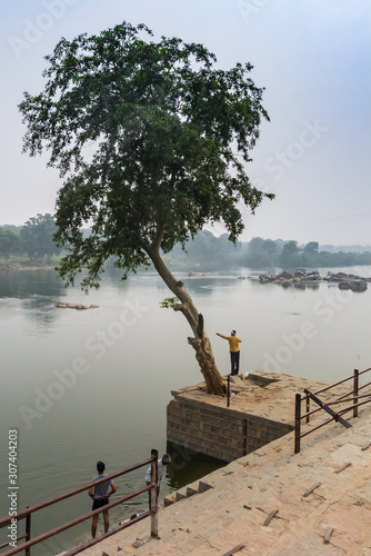 Men fishing the river in historic town Orchha, India photo