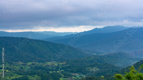 Valley in Na Haeo District with mountains and cloud sky in the background, Loei, Thailand. © Sitthipong
