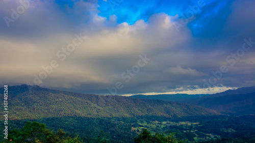 Valley in Na Haeo District with mountains and cloud sky in the background, Loei, Thailand.
