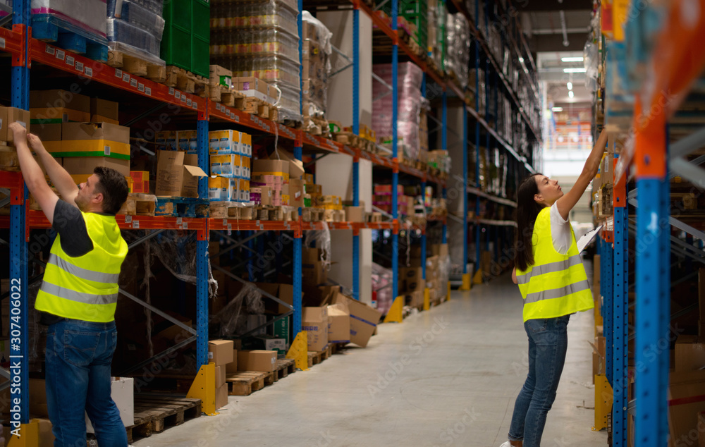 Warehouse workers make a list of goods