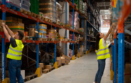 Warehouse workers make a list of goods