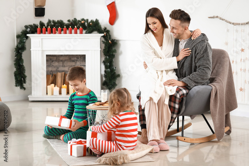 Happy family in pajamas ope...