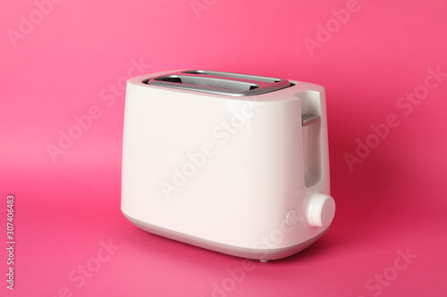 Toaster for bread on pink background, space for text