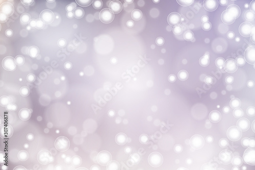 Silver bokeh background. Christmas glowing lights with sparkles. Holiday decorative effect.