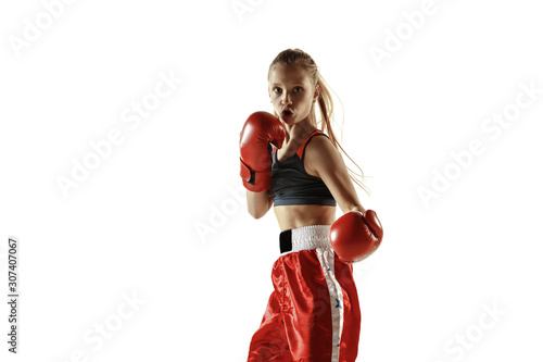 Young female kickboxing fighter training isolated on white background. Caucasian blonde girl in red sportswear practicing in martial arts. Concept of sport, healthy lifestyle, motion, action, youth.