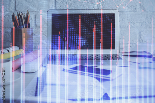 Stock market graph and table with computer background. Double exposure. Concept of financial analysis. © peshkova