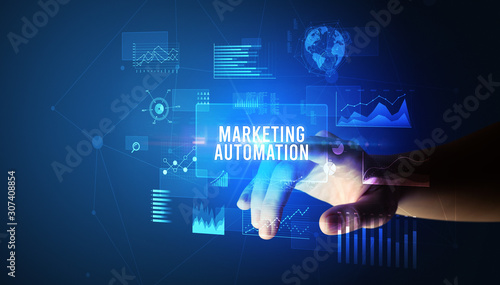 Hand touching MARKETING AUTOMATION inscription, new business technology concept