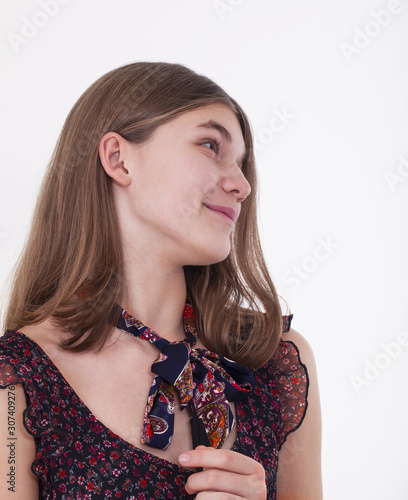 Smiling girl in summer dress in profile on a white background