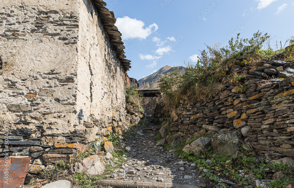 The narrow  streets of Ushguli village on a background of mountains in Svaneti in the mountainous part of Georgia