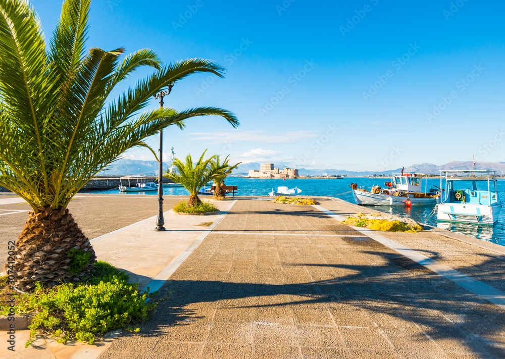 Fototapeta premium Nafplio city sea promenade with Bourtzi castle on background in Greece