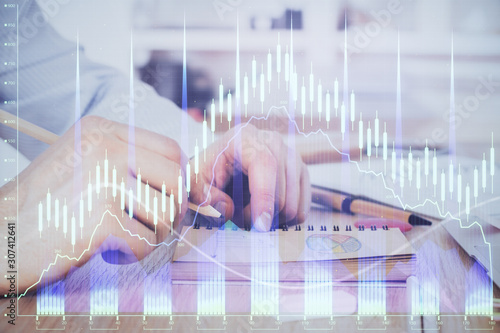 Multi exposure closeup hands with stock market forex graph.