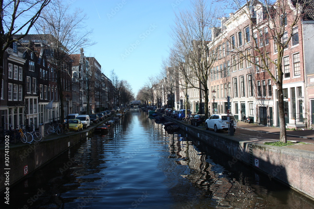 the canals of the rivers of Amsterdam and the buildings on the street in the capital