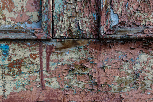 old wood wall with peeling paint © Laura