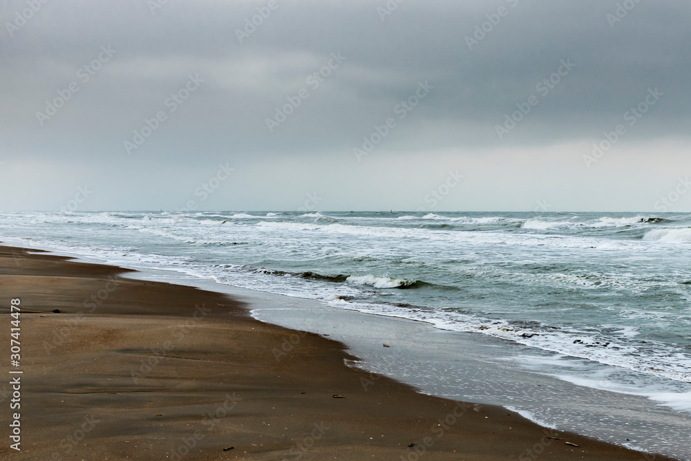 Koksijde, Belgium - November 15, 2019: A wild North Sea on a dark cloudy day