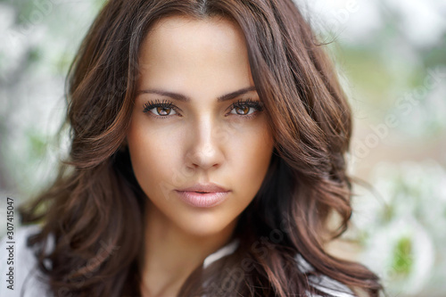 Beautiful brunette woman face close up - perfect skin