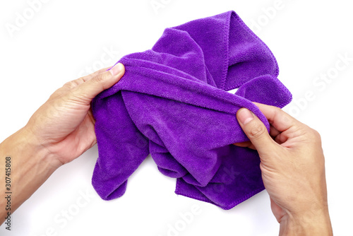 The man hand holding microfiber fabric cleaning cloth on white background.