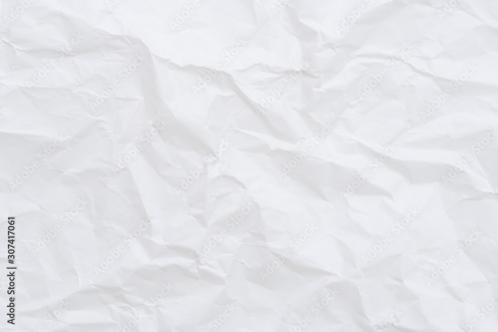 Modern crumpled white paper on empty sheet gray background with light shadows for creative wallpaper, card, art work design.