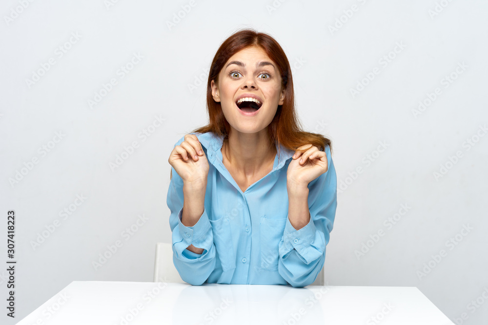 portrait of a young woman sitting at desk portrait of a young woman sitting at desk