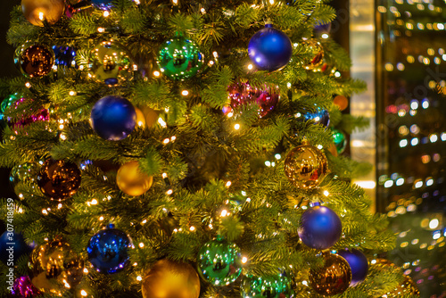 Colorful glass baubles and bokeh on a Christmas tree in Zurich - 1